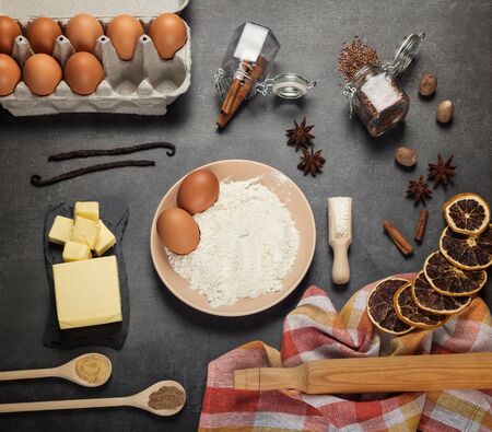 A set of products for the preparation of dough, spices, dry citrus on gray work surfaceの写真素材