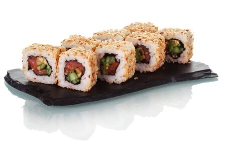 Sushi rolls arranged on special black plate isolated on white backgroundの写真素材