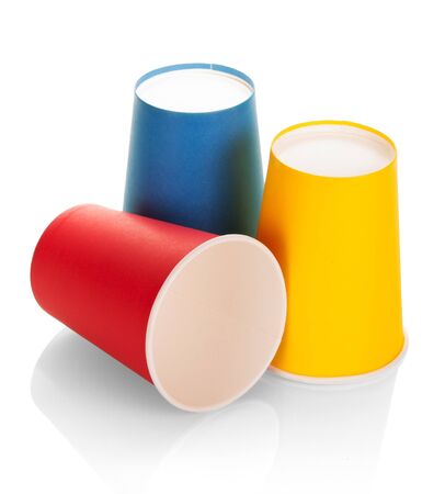 Three multi colored disposable plastic cups isolated on white backgroundの写真素材