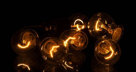 Incandescent lamps in operation, isolated on black backgroundの写真素材