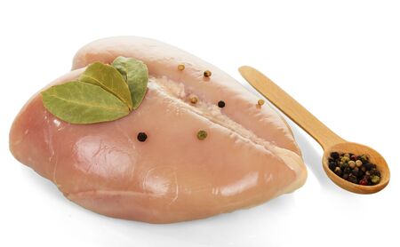 Fresh chicken fillet and Bay leaf, black pepper peas in wooden spoon isolated on white backgroundの写真素材