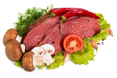 Fresh veal tenderloin, mushrooms, tomato and spices, on lettuce leaves isolated on white backgroundの写真素材