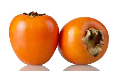 Two ripe persimmon fruits isolated on white backgroundの写真素材