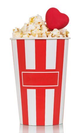 Large glass of popcorn with red heart isolated on white backgroundの写真素材