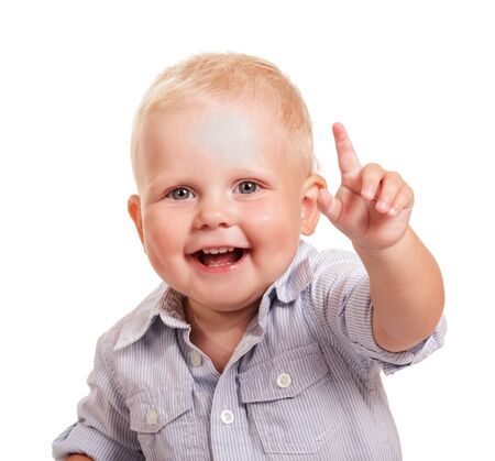 Portrait of a happy boy in a bright shirt with a raised hand isolated on white background.の写真素材
