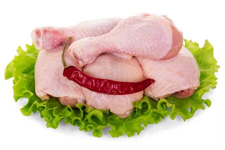 Raw chicken legs, salad leaves and red pepper isolated on white background.の写真素材