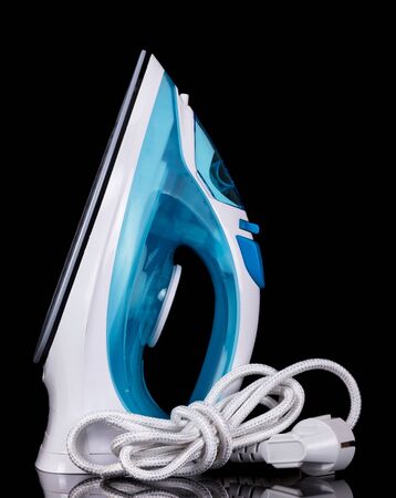 Modern steam iron isolated on a black background.の写真素材