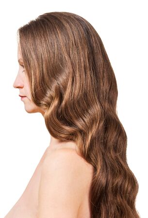 A woman with wavy brown hair isolated on white background.の写真素材