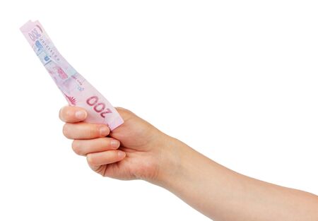 Ukrainian money 200 hryvnia in a female hand isolated on white background.の写真素材