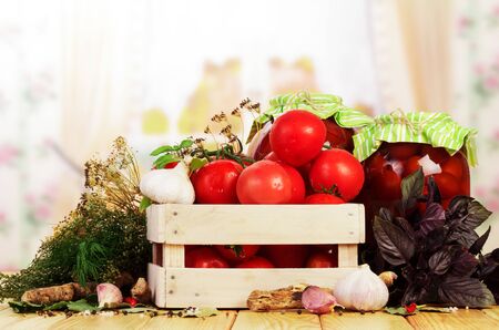 Box of fresh and canned tomatoes with spices isolated on white background.の写真素材