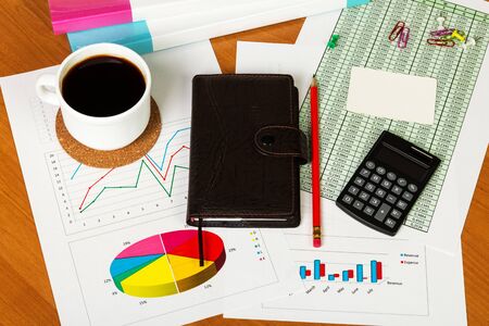 Blank card, calculator, coffee cup, notebook and office supplies on the desktop background.の写真素材