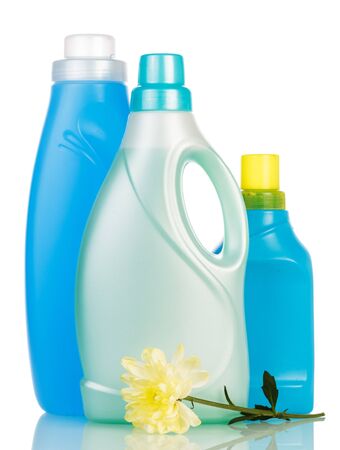 Plastic bottles of cleaning products and a flower isolated on white background.の写真素材
