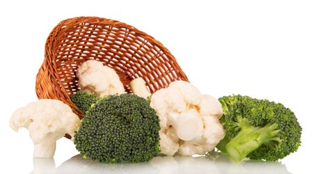 Wicker basket with broccoli and cauliflower close up isolated on white background.の写真素材