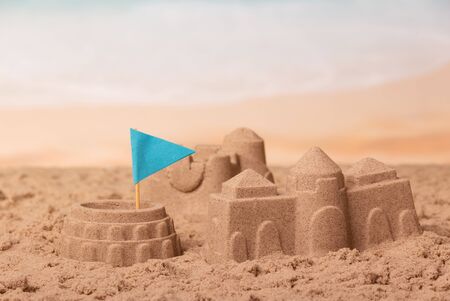 Coliseum with the flag and towers in the sand against the sea.の写真素材