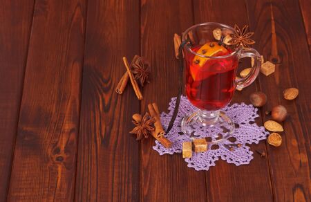 Mulled wine, nuts and candy on background of dark wood.の写真素材
