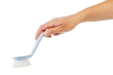Woman's hand holding a brush for cleaning isolated on white background.の写真素材