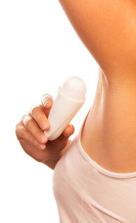 Woman applying deodorant isolated on white background.の写真素材