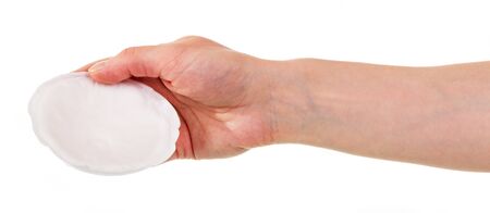 Breast gasket in a female hand isolated on white background.の写真素材