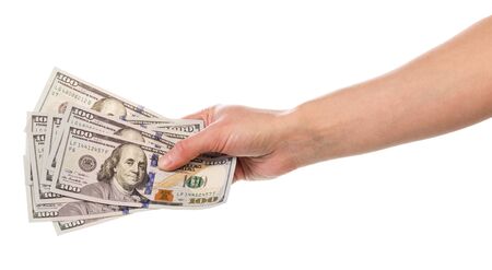 Hundred dollar denominations in a female hand isolated on white background.の写真素材