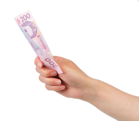 Ukrainian money 200 hryvnia in a female hand isolated on white background.の写真素材