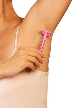 Hand woman shaves armpit disposable razor isolated on white background.の写真素材