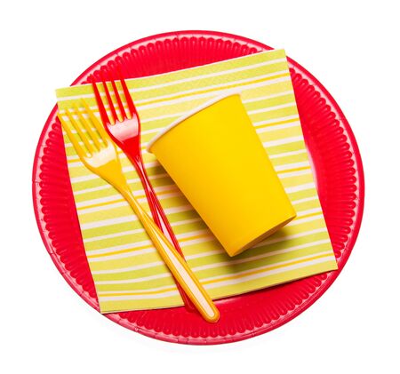 Bright disposable plates, paper cups, plastic forks napkin isolated on white background.の写真素材
