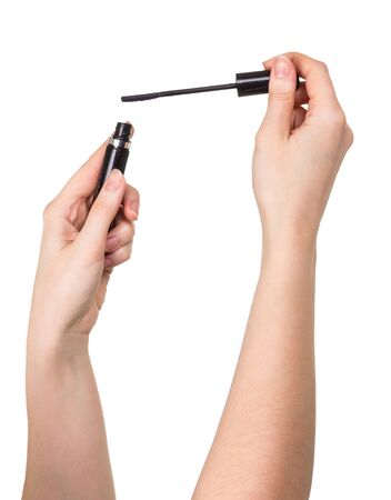 Mascara in female hands isolated on white background.の写真素材