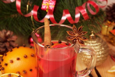 Mulled wine, pine cones and Christmas ball on the background of the Christmas tree.の写真素材