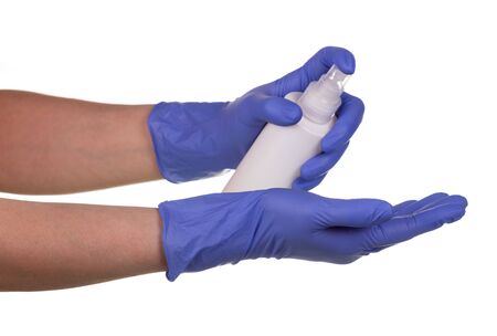Hand treatment in medical gloves with a sanitizer close-up isolated on a white background.の写真素材