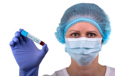 the laboratory assistant holds in his hand a test tube with a negative test for coronavirus. Isolated on a white background.の写真素材