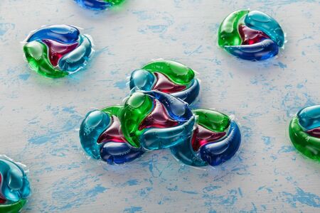 Capsules for washing close-up on a blue abstract background. Top viewの写真素材