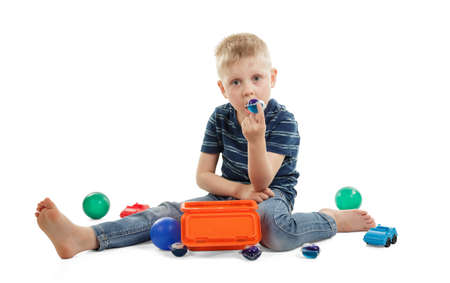 The child is eating a capsules for washing isolated