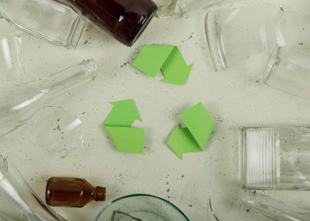 Environment protection. Recycling concept. Various waste glass bottles, broken dishes, bubblesの写真素材