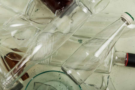 Top view. Waste glass. Various beer and wine bottles, shards on a light backgroundの写真素材