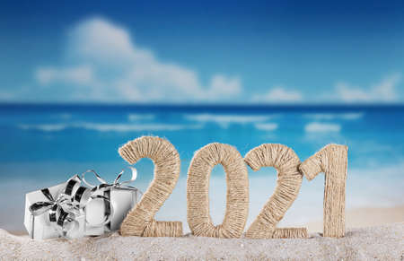 New Year 2021 on the beach. Snowman and Christmas gifts in the sandの写真素材