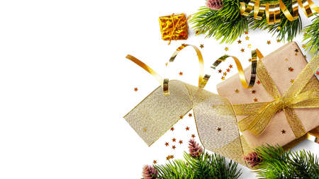 Golden ribbon and festive gift wrapping, christmas tree branch isolated on white backgroundの写真素材