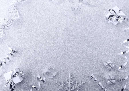 Top view. Christmas background image. Bright silver background with ribbons and giftsの写真素材