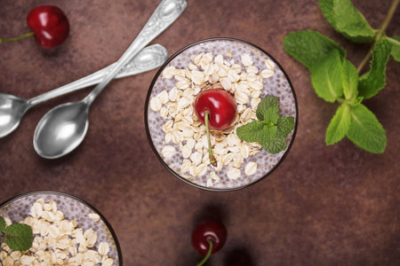 Healthy food concept. Dessert with oatmeal and chia seeds garnished with cherries. Top viewの写真素材