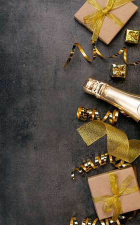 Top view. Golden gifts and ribbon, Christmas tinsel and bright gifts on a dark backgroundの写真素材