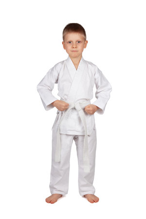The sport is karate. Serious boy in white kimono isolated on white backgroundの写真素材