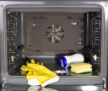 Household homework. Cleaning a dirty oven. Gloves and oven cleanersの写真素材