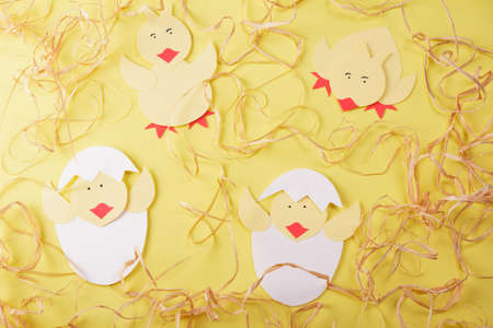 Children's paper craft. Handmade chickens on a bright backgroundの写真素材