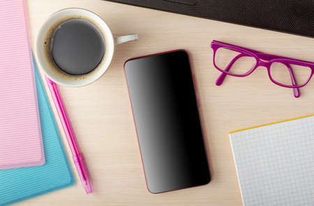 Business concept. Top view. Folders with financial documents, invigorating coffee and gadgets, a phone for workの写真素材