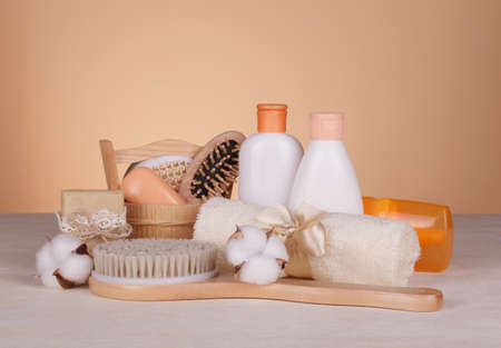 SPA set for home use. Body brush, scented soaps and skin care products on beige backgroundの写真素材
