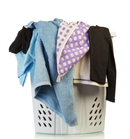 Large basket of assorted dirty laundry isolated on white backgroundの写真素材