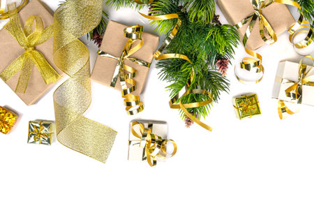 Top view. Christmas branch, golden ribbon and new year gifts isolated on white backgroundの写真素材
