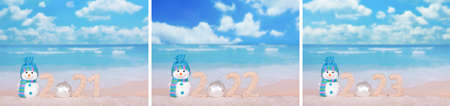 Horizontal collage of calendars. Figures 2022 on the beach in the sand with a snowmanの写真素材