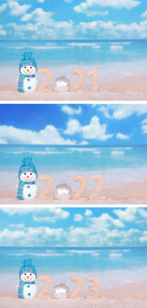 Year change concept. Vertical calendar with snowman and date on the background of the sea in the sandの写真素材