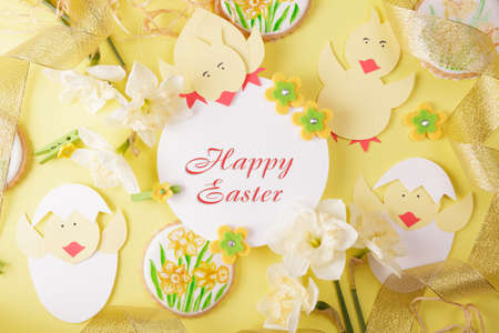 happy easter. Paper chicken figurines, gingerbread cookies and a festive inscriptionの写真素材