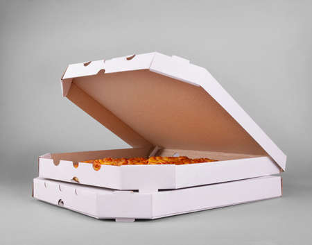 Two boxes of juicy hot margarita pizza on a gray backgroundの写真素材